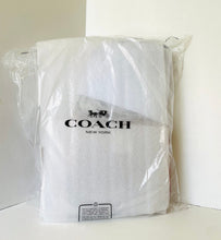Load image into Gallery viewer, White towel with Coach logo in clear packaging on a white background