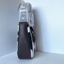 Load image into Gallery viewer, Brown leather handbag with cow print pattern on a white background