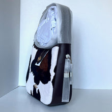 Load image into Gallery viewer, Cow print bag with gray interior on a white background