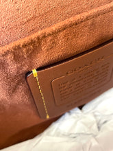 Load image into Gallery viewer, Close-up of a brown leather product with a label on a white background