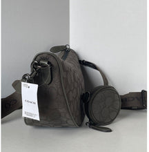 Load image into Gallery viewer, Coach bag with a tag on a light gray background