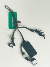 Load image into Gallery viewer, Black electronic device with a cord and attached tag on a white background