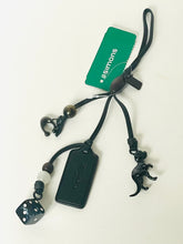 Load image into Gallery viewer, Black lanyard with decorative elements and a green tag on a white background