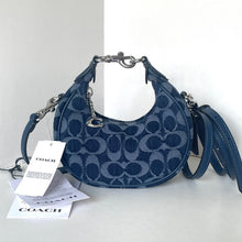 Load image into Gallery viewer, Blue Coach handbag with a tag on a white background