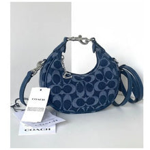 Load image into Gallery viewer, Blue Coach handbag with a tag on a white background