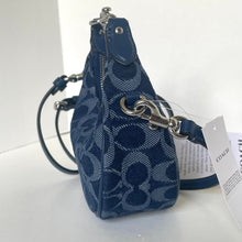 Load image into Gallery viewer, Blue patterned handbag with a Coach tag on a white background