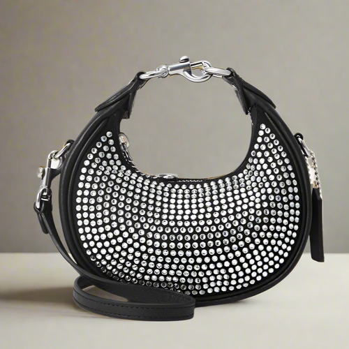 coach Black handbag with silver studs on a white background crossbody
