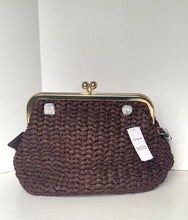 Load image into Gallery viewer, A dark brown woven clutch purse with a gold-tone kiss-lock frame and a white COACH brand tag, set against a plain white background.