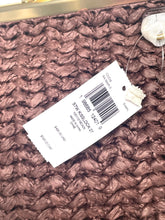 Load image into Gallery viewer, A close-up of a brown textured woven rug with a white product tag attached, showing a barcode and size information.