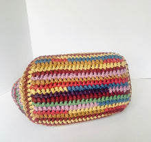 Load image into Gallery viewer, A handmade woven straw bag with horizontal stripes of yellow, red, pink, blue, and green, photographed on a plain white background.