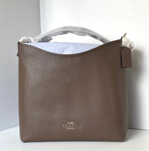 Load image into Gallery viewer, Brown leather handbag with visible brand logo on a light gray background