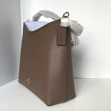 Load image into Gallery viewer, Brown leather handbag with a visible brand logo on a white background
