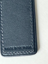 Load image into Gallery viewer, Close-up of a dark navy leather item showing fine grain texture, contrast stitching, and an embossed 'MADE IN VIETNAM' mark on a light off-white background.