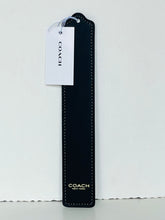 Load image into Gallery viewer, A Coach leather keychain or bookmark in black with white contrast stitching, featuring a white hanging tag with the Coach logo and gold 'COACH NEW YORK' text near the bottom.
