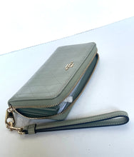 Load image into Gallery viewer, A Coach quilted zip-around wallet in light gray leather with a matching wristlet strap and gold-tone hardware, photographed on a white surface.