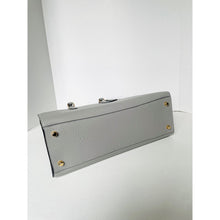 Load image into Gallery viewer, Gray clutch bag with gold accents on a white surface