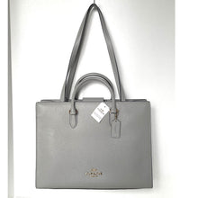 Load image into Gallery viewer, Gray Coach handbag with a tag on a white background