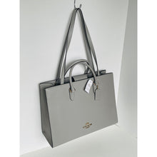 Load image into Gallery viewer, Gray handbag with a visible brand tag on a white background
