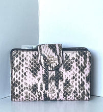 Load image into Gallery viewer, A rectangular clutch bag with a snakeskin pattern in black and light pink, featuring a central flap closure with a gold-tone metal logo clasp. The brand name 'GUESS' is visible on the clasp.