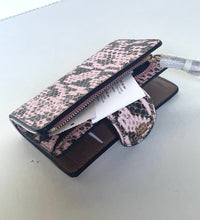 Load image into Gallery viewer, A pink and brown snakeskin-patterned zip-around wallet shown open, with card slots, a coin pocket, and a small attached pouch, photographed on a light neutral surface.