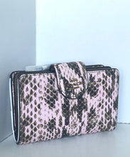 Load image into Gallery viewer, A Coach snakeskin-pattern clutch bag in pink and brown, featuring a front flap with a metal logo plate and a white interior lining visible on the left side.