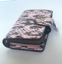 Load image into Gallery viewer, A pink and black leopard print wallet with a gold-tone logo clasp and zipper, resting on a light gray surface.