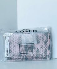 Load image into Gallery viewer, A Coach New York clutch in clear plastic packaging, featuring a pink and gray leopard print pattern.