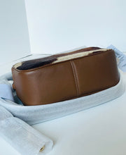 Load image into Gallery viewer, Brown leather bag on a white surface with a gray towel