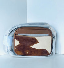 Load image into Gallery viewer, Fanny pack with brown and white cowhide leather section on a light blue background