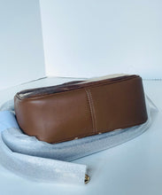 Load image into Gallery viewer, Brown leather clutch bag on a light gray surface with a white background