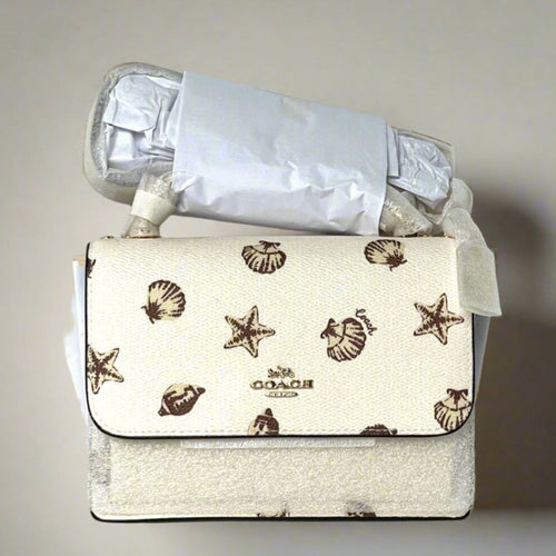 Coach handbag with starfish pattern on a white surface