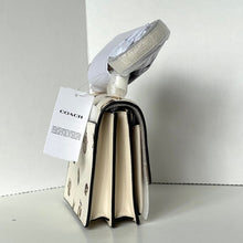 Load image into Gallery viewer, Coach handbag with a tag on a white background