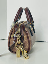 Load image into Gallery viewer, Small brown handbag with gold zipper and tag on a white background
