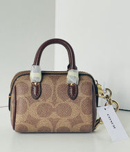 Load image into Gallery viewer, Coach handbag with a matching keychain on a white background