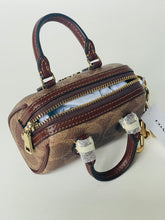 Load image into Gallery viewer, Brown handbag with gold zippers on a white background