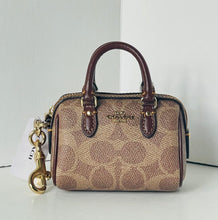 Load image into Gallery viewer, Coach handbag with a matching keychain on a white background