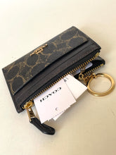 Load image into Gallery viewer, Black Coach wallet with gold accents and keychain on a beige background