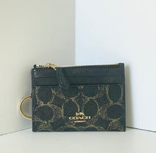 Load image into Gallery viewer, Coach wallet with gold logo on a white background