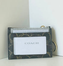 Load image into Gallery viewer, Coach cardholder on a white surface with a light gray background
