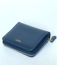 Load image into Gallery viewer, A navy blue leather Coach zip-around wallet with gold-tone hardware and a gold logo on the front, photographed on a plain white background.