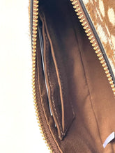Load image into Gallery viewer, Close-up of an open brown leather zippered pouch or clutch, showing a gold-tone zipper, interior card slots, and a light-colored animal-print exterior on the right side.
