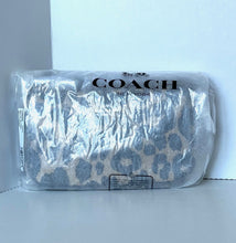 Load image into Gallery viewer, Coach pouch in clear plastic packaging on a white background