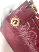 Load image into Gallery viewer, Close-up of a red textured wallet with gold accents on a white background