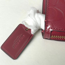 Load image into Gallery viewer, Red wallet with a white cloth on a light background