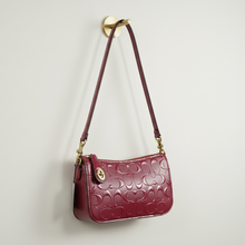 Load image into Gallery viewer, Red handbag with gold accents on a white background