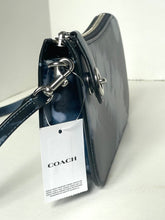 Load image into Gallery viewer, A Coach shoulder bag in dark navy blue patent leather with silver-tone hardware and a white COACH hangtag attached, photographed on a light neutral surface.