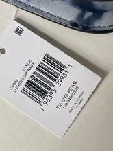 Load image into Gallery viewer, A close-up of a white product tag with a barcode and text reading 'CL046 LINGB LHMIDNIGHT NAVY' and 'TIE DYE PENN,' alongside a partial view of a navy blue tie-dye shoe in the upper corner.