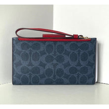Load image into Gallery viewer, Blue patterned clutch with red wrist strap on a white background