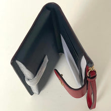 Load image into Gallery viewer, Black wallet with a red strap on a white background