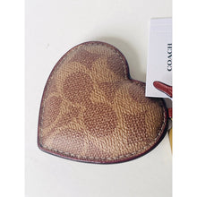 Load image into Gallery viewer, Heart-shaped brown textured pouch with a Coach tag on a white background